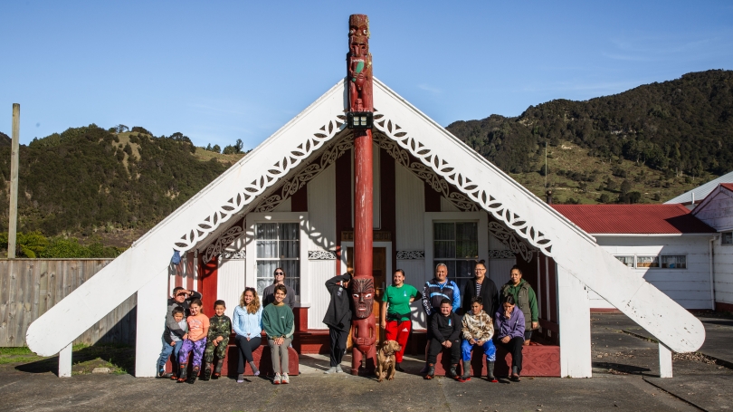 People in front of traingular New Zealand traditional marae