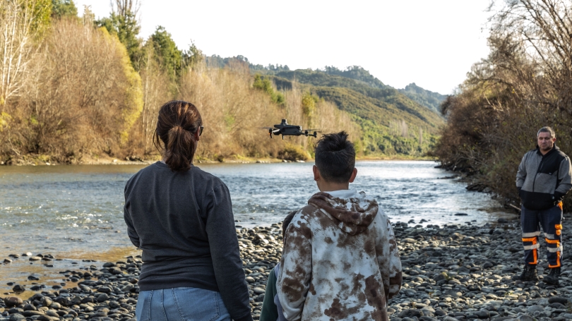 woman and child standing near river